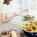 Close-up of woman having dinner with roasted chiken with potato served with green salad