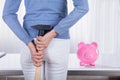 Woman Hiding Hammer To Break Piggybank Royalty Free Stock Photo