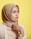 close up woman hijab with an expression happy thinking something