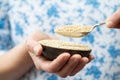 Close Up Of Woman Holding Bowl Of Amaranth