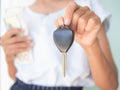 Close up woman holding car keys blur holding bank note