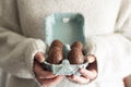 Close up of woman holding carton egg box with easter chocolate eggs Royalty Free Stock Photo