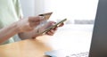 Close-up Of A Woman Holding Credit Card In Hand Doing Online Shopping Using Smart Phone Royalty Free Stock Photo