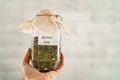 Close-up, a woman holding a dry useful herb for brewing