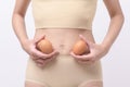 Close up woman holding eggs on belly , prepare reproductive fertility , Ovulation stimulation , matherinty concept Royalty Free Stock Photo