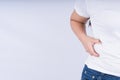 Close-up woman holding excessive belly fat, overweight abdomen on white background. Weight loss, diet lifestyle, healthy concept Royalty Free Stock Photo