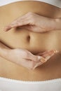 Close Up Of Woman Holding Hands In Front Of Stomach In Circular Royalty Free Stock Photo