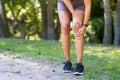 Close up of woman holding knee in pain, sports injury inflammation trail run Royalty Free Stock Photo