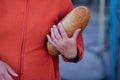 Close up of woman holding loaf of white bread