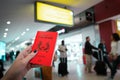 Close up of woman holding a passport of Singapore at the Airport Royalty Free Stock Photo