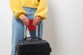 Close-up woman holding a passport and travel bag in her hands. Travel, immigration, emigration