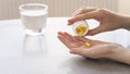 Close up woman holding pill in hand with water. Female going to take tablet from headache, painkiller, medication drinking clear w Royalty Free Stock Photo