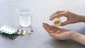 Close up woman holding pill in hand with water. Female going to take tablet from headache, painkiller, medication drinking clear w Royalty Free Stock Photo