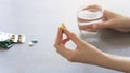 Close up woman holding pill in hand with water. Female going to take tablet from headache, painkiller, medication drinking clear w Royalty Free Stock Photo