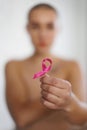 Close-up of woman holding pink ribbon, concept of breast cancer awareness. Royalty Free Stock Photo