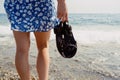 Close-Up of Woman with Sandals by the Sea