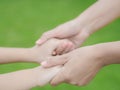 Close up of woman holds the hand of a lovely child. Royalty Free Stock Photo