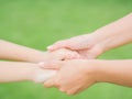 Close up of woman holds the hand of a lovely child. Royalty Free Stock Photo