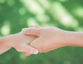 Close up of woman holds the hand of a lovely child. Royalty Free Stock Photo