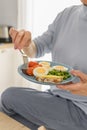 Close up woman holds Healthy Breakfast of boiled eggs and steamed vegetables on plate, balanced breakfast concept. Royalty Free Stock Photo