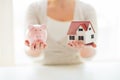 Close up of woman with house model and piggy bank Royalty Free Stock Photo