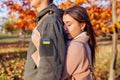 Close up of woman hugging husband in ukrainian military uniform with flag chevron from back. Sad stressed couple Royalty Free Stock Photo