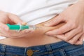 Close up on woman injecting her belly Royalty Free Stock Photo