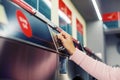 Woman inserting coin in self service washing machine close-up Royalty Free Stock Photo