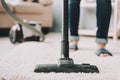 Close up. Woman Cleans Carpet with Vacuum Cleaner. Royalty Free Stock Photo