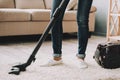 Close up. Woman Cleans Carpet with Vacuum Cleaner. Royalty Free Stock Photo