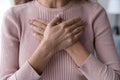 Close up of woman keep hands at chest show gratitude