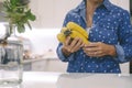 Close up of woman in the kitchen holding bananas fruit and living real life lifestyle. Healthy nutrition food and female. Dieting