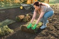 Young woman laying sod for new garden lawn - turf laying concept Royalty Free Stock Photo