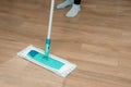 Close up of woman legs with mop cleaning floor at home Royalty Free Stock Photo