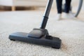 Close up of woman legs with vacuum cleaner at home Royalty Free Stock Photo