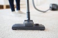 Close up of woman legs with vacuum cleaner at home Royalty Free Stock Photo