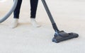 Close up of woman legs with vacuum cleaner at home Royalty Free Stock Photo