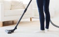 Close up of woman legs with vacuum cleaner at home Royalty Free Stock Photo