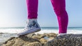 Close up of woman legs wearing a pair of red sneakers, isolated on white