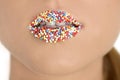 Close up of woman lips with multicolored pearls