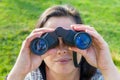 Close up woman looking through binoculars