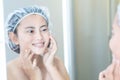Close up woman looking her face in the mirror with smiling after bath, health care and beauty Royalty Free Stock Photo