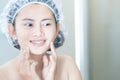 Close up woman looking her face in the mirror with smiling after bath, health care and beauty Royalty Free Stock Photo