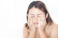 Close up woman looking reflection in the mirror for washing face with foam in the bathroom, health care and beauty concept Royalty Free Stock Photo