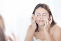 Close up woman looking reflection in the mirror for washing face with foam in the bathroom, health care and beauty concept Royalty Free Stock Photo