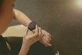 Close up of fitness woman looking at smartwatch on her wrist while resting after work out Royalty Free Stock Photo