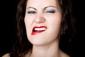 Close-up woman looks straight into the camera on a black background. expresses different emotions, showing teeth, biting Royalty Free Stock Photo