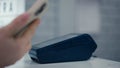 Close-up. A woman makes a payment using NFC technology using a mobile phone. NFC in a mobile phone. Payment using NFC.