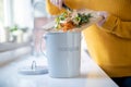 Close Up Of Woman Making Compost From Vegetable Leftovers In Kitchen Royalty Free Stock Photo