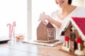 Close up of woman making gingerbread houses